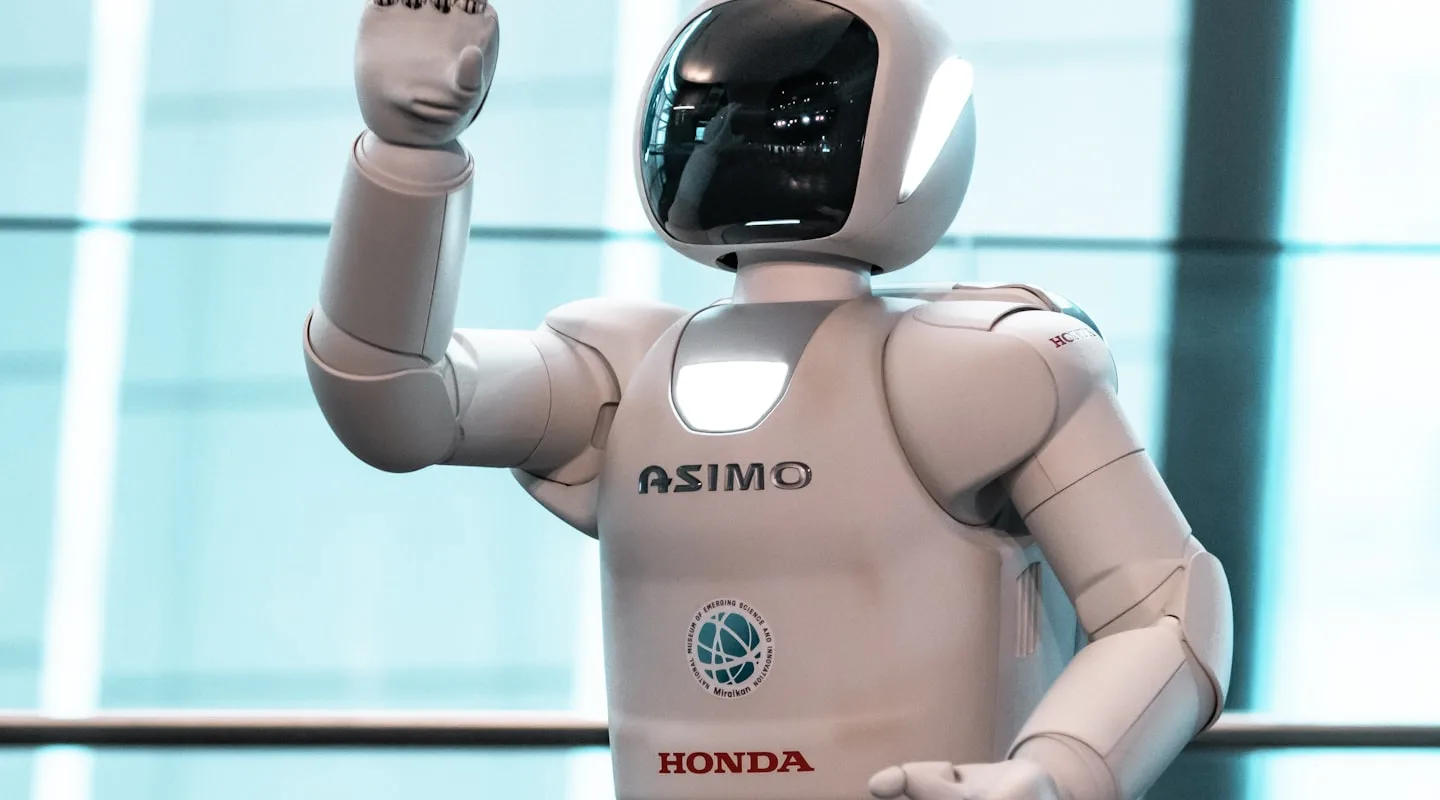 Honda ASIMO humanoid robot waving at the Miraikan science museum in Tokyo